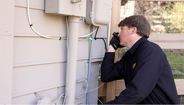 A Critter Control technician expecting possible entryways